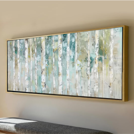 a large, framed painting of a forest scene with tall trees and a light blue background.
