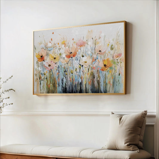a large, colorful painting of flowers hanging on a wall above a bench.
