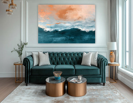 a living room with a large, colorful painting of a beach scene hanging on the wall above a green velvet sofa. The sofa is accompanied by two round coffee tables, and there is a lamp and a vase on a side table. The room has a modern and stylish design, with a large window providing natural light and a rug on the floor.