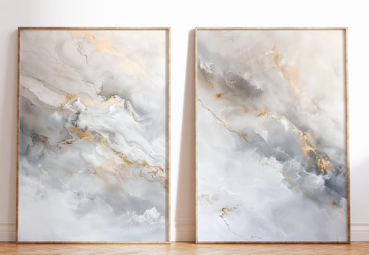 two large paintings with abstract, marble-like patterns in shades of gray and white, with gold accents. The paintings are framed and displayed on a wall, creating a visually striking and artistic composition.