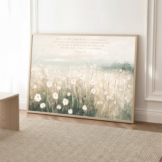A framed painting depicting a field of white flowers against a pale blue sky, with a text overlay that reads "Trust in the Lord with all your heart, and lean not on your own understanding, in all your ways acknowledge Him, and be known to direct your paths."