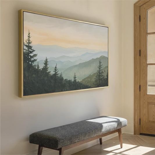 a large landscape painting hanging on a wall, depicting a serene mountain scene with pine trees and a hazy, golden sky. In the foreground, there is a gray bench positioned against the wall, providing a seating area for viewers to appreciate the artwork.