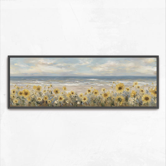 A framed painting depicting a field of yellow sunflowers overlooking a beach with the ocean in the background.