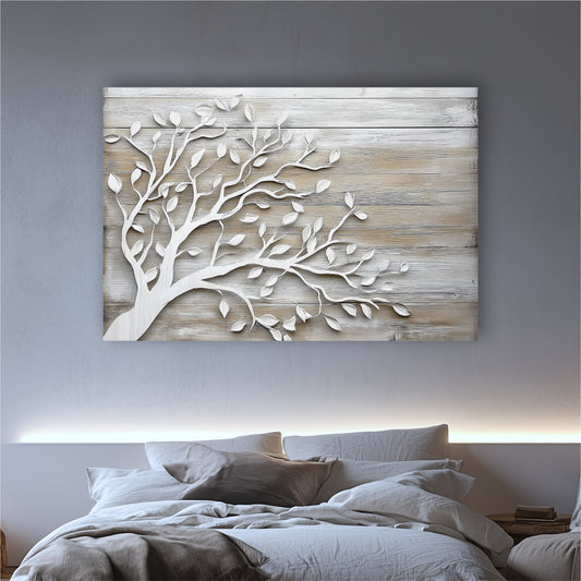 a large wooden wall art piece depicting a tree with white leaves, hanging above a bed with white pillows and a gray blanket.