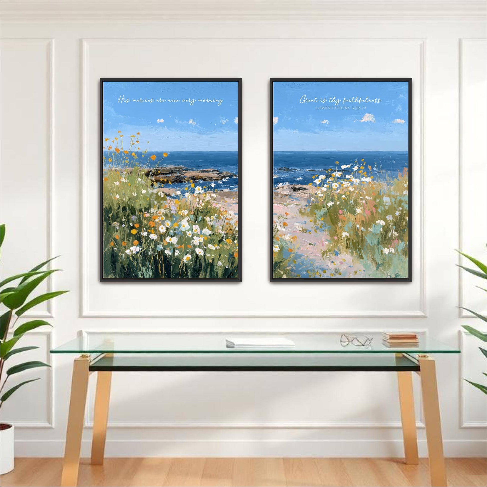 two framed paintings of a serene landscape with a field of flowers and a body of water, hanging on a white wall above a glass table.