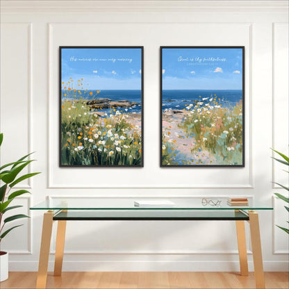 two framed paintings of a serene landscape with a field of flowers and a body of water, hanging on a white wall above a glass table.