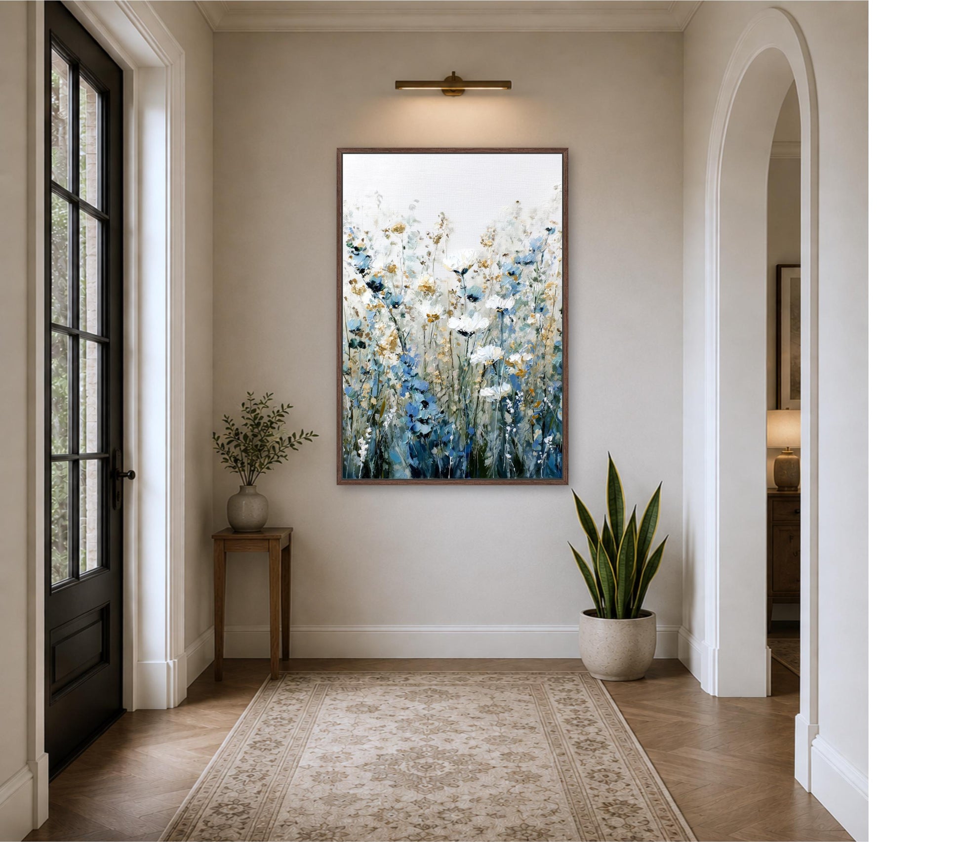 a hallway with a large painting of flowers hanging on the wall, a small table with a plant, and a rug on the floor.