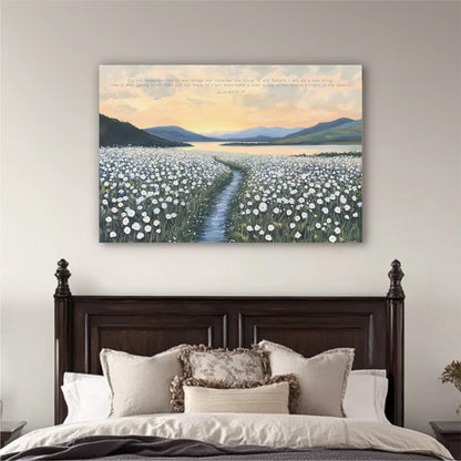 a serene bedroom scene with a large bed adorned with white pillows and a brown headboard. Above the bed, a large canvas print depicting a field of white flowers stretches across the wall, with a winding path leading through it. The sky above is a beautiful gradient of orange and blue, creating a peaceful and tranquil atmosphere.