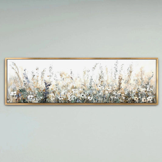 A framed painting depicting a field of flowers with a pale blue sky in the background.