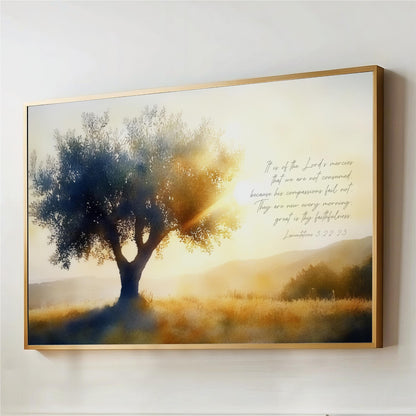 The image is a framed painting depicting a serene landscape with a large tree in the foreground and a hazy, golden-hued background. The painting is set against a white wall, and there is a Bible verse from the book of James, which reads "It is of the Lord's mercy that we are not consumed because his compassion fails not. They are new every morning."