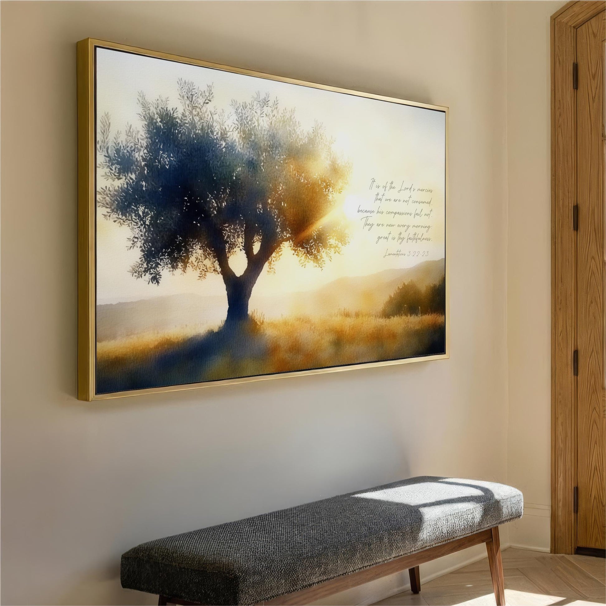 a large framed painting of a tree with a golden sunset in the background, hanging on a wall above a gray bench.