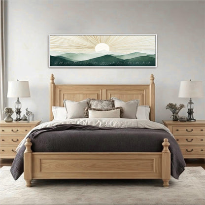 a large wooden bed with a gray comforter and pillows, flanked by two nightstands with lamps. Above the bed is a framed artwork depicting a sunrise over mountains.