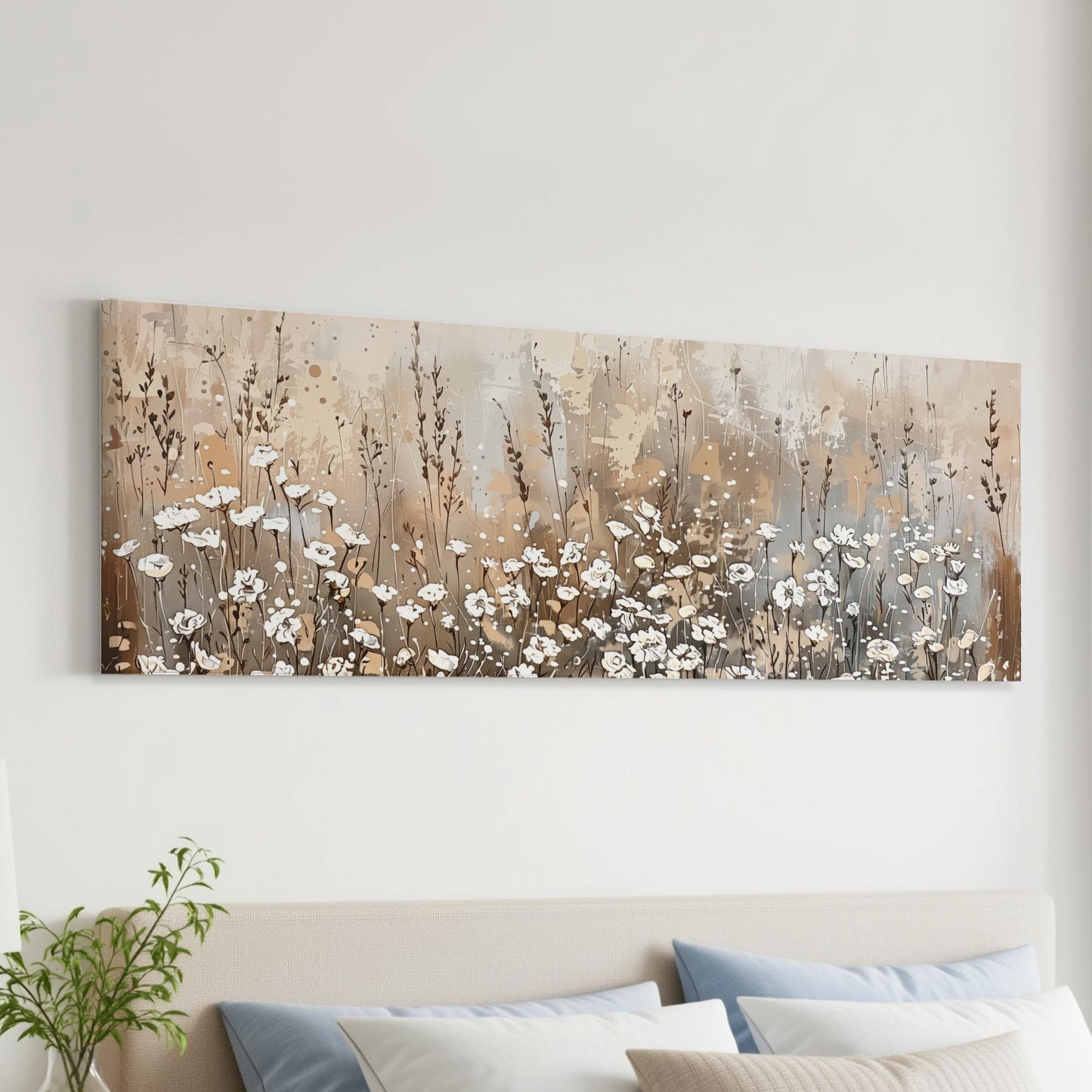 a large painting of a field of flowers hanging on a wall above a bed with pillows.