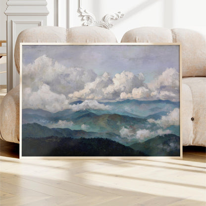 a large framed painting depicting a mountainous landscape with clouds in the sky.