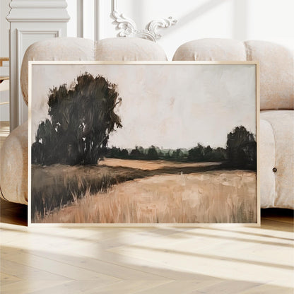 a large, framed painting depicting a serene landscape with a field and trees in the background.