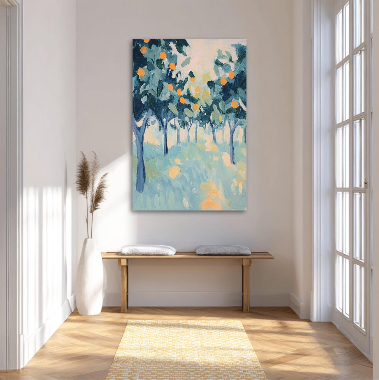 a large painting of a tree-filled landscape hanging on a white wall in a bright, airy room with a wooden bench and a white vase.