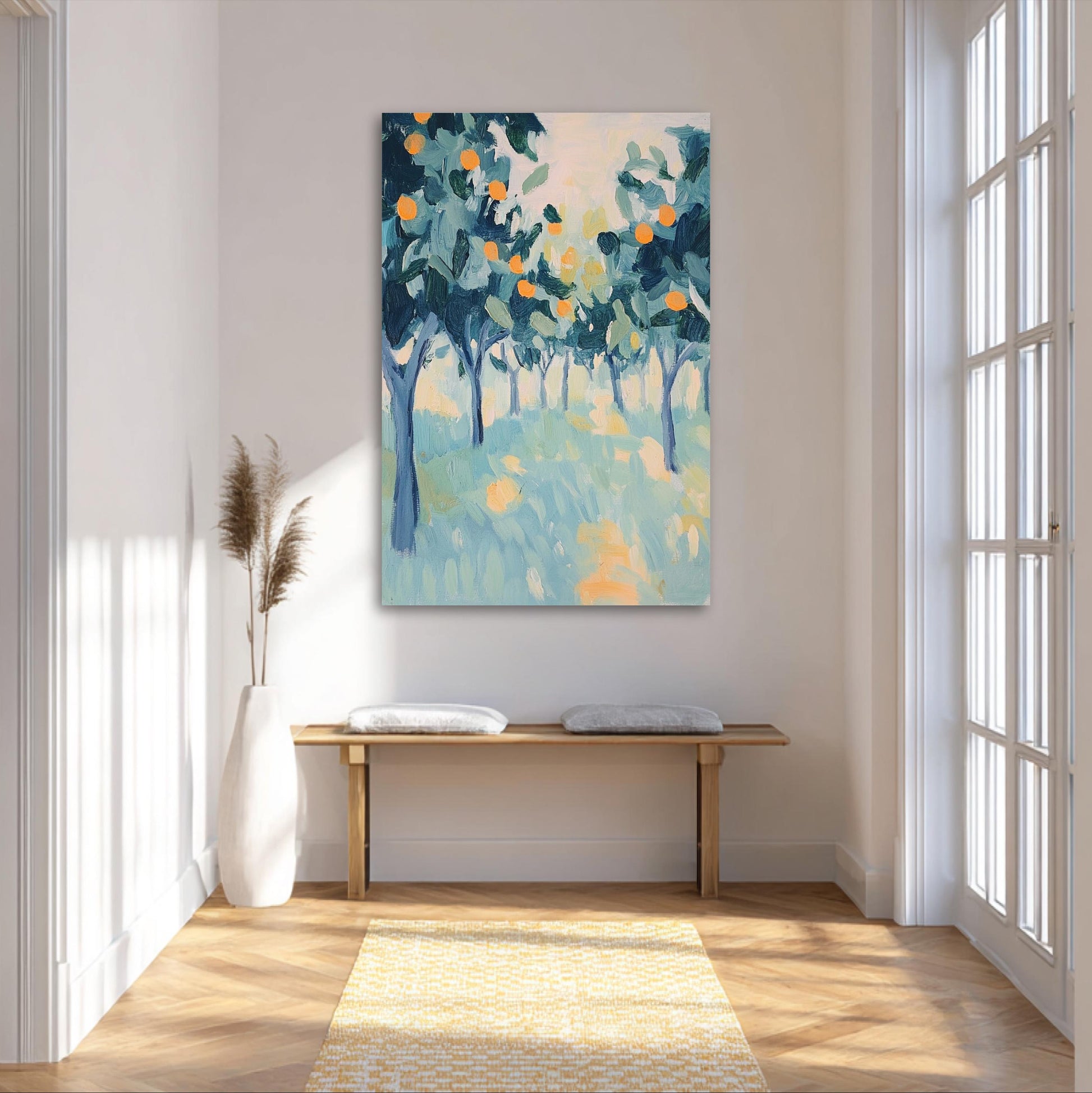 a large painting of a tree-filled landscape hanging on a white wall in a bright, airy room with a wooden bench and a white vase.