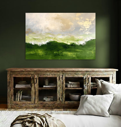 a large, vibrant painting of a green landscape hanging on a wall above a wooden cabinet with glass doors. The cabinet has several books and decorative items displayed on its shelves. The room has a cozy, inviting atmosphere with a couch and a rug in the foreground.