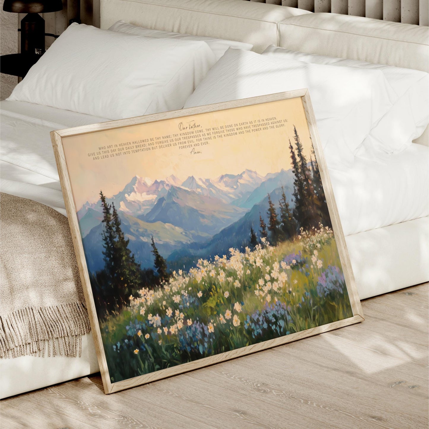 a framed painting of a mountain landscape with a field of flowers in the foreground.