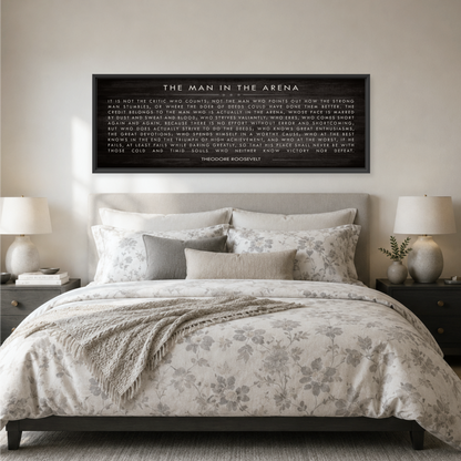 a bedroom with a large bed, a framed quote on the wall, and two lamps on nightstands.