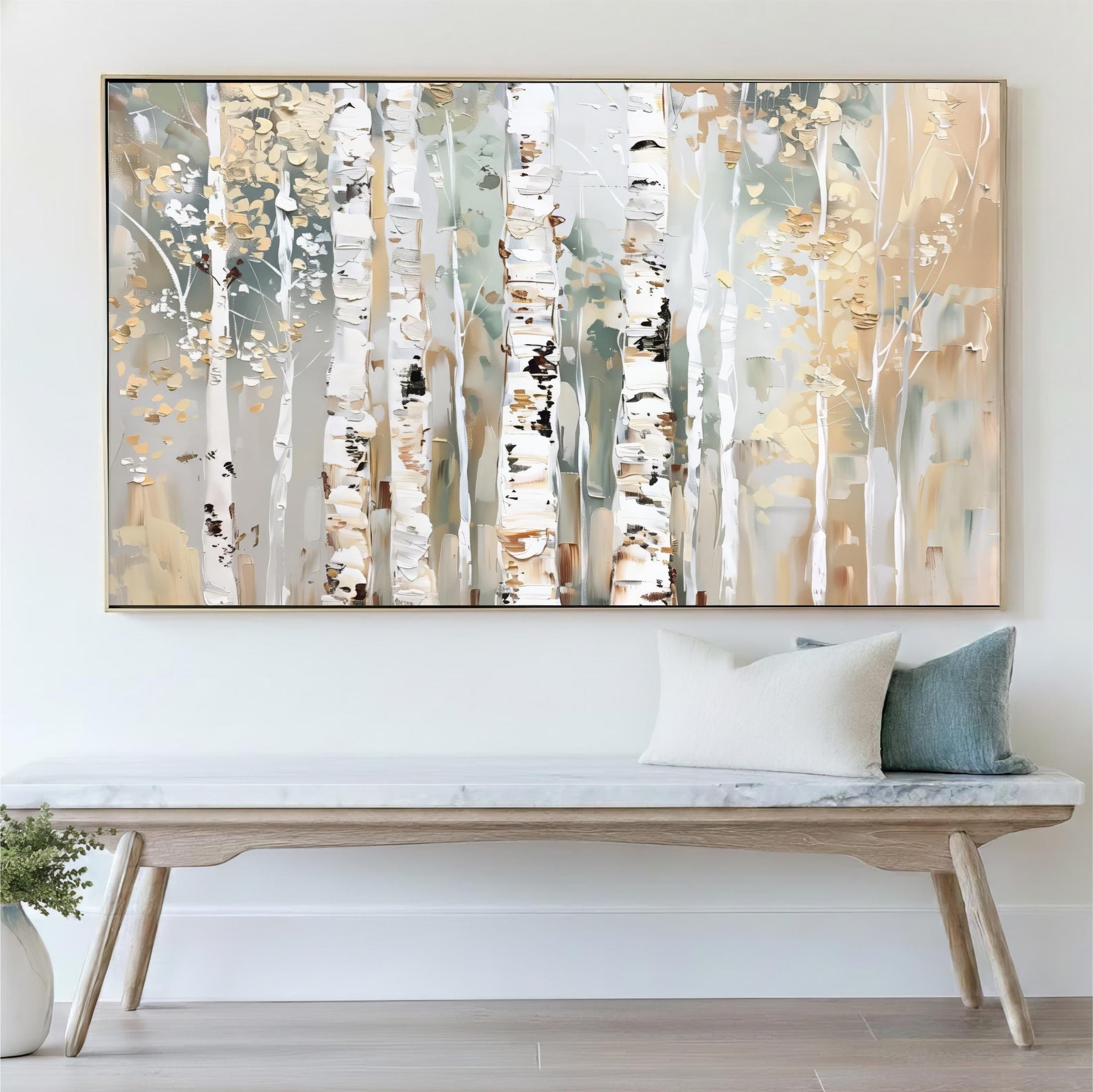 a large painting of birch trees with a white and beige color palette, hanging on a wall above a wooden bench with a marble top.