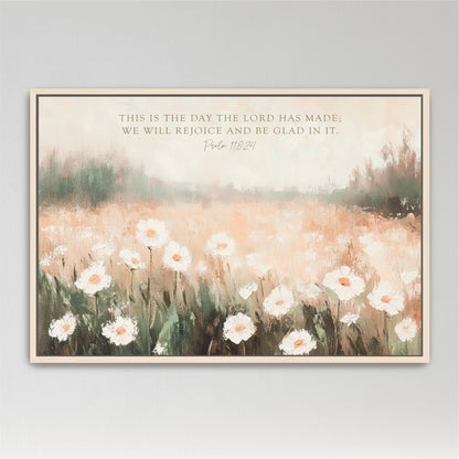 The image is a framed painting depicting a field of white flowers against a blurred background, with a text overlay that reads "This is the day the LORD has made, we will rejoice and be Glad in it. Psalm 118:24".
