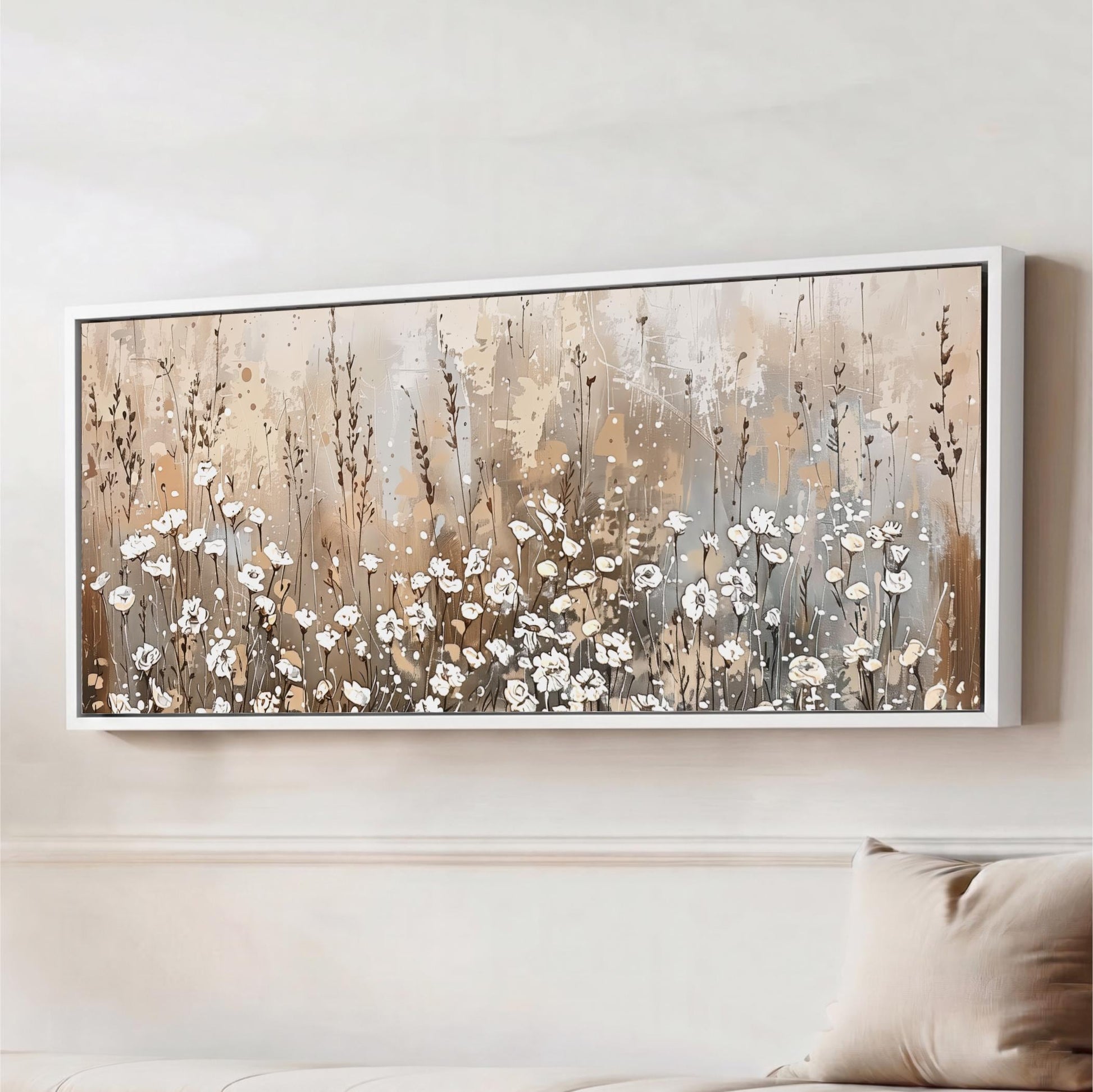 a large framed painting hanging on a wall, depicting a field of flowers with a mix of white and brown colors.