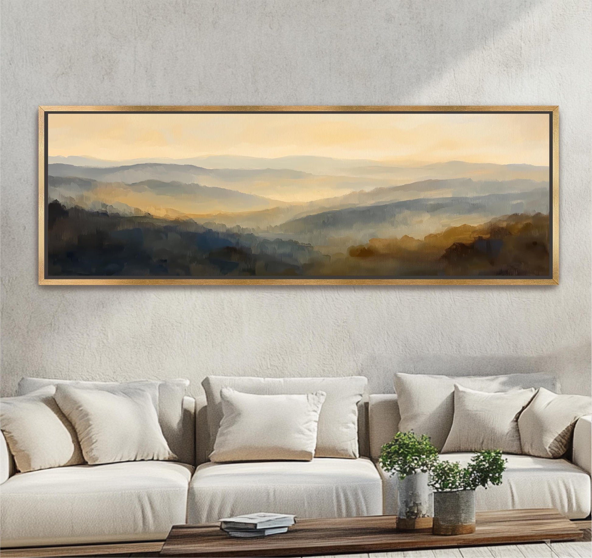 a large, framed painting of a scenic landscape hanging on a wall above a couch with white cushions.