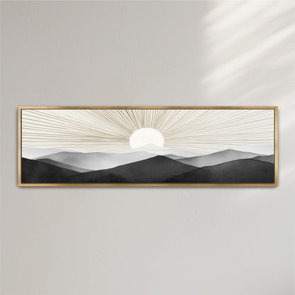 A framed artwork depicting a serene landscape with a sun rising over a mountain range, creating a striking contrast between the warm, golden rays and the cool, dark silhouettes of the mountains.