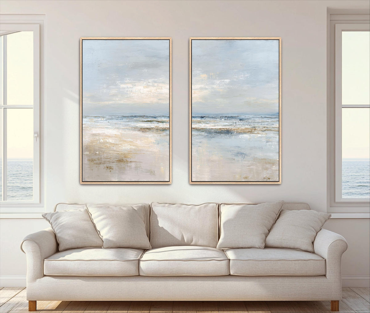 two large paintings of a serene ocean scene, hanging on a wall above a beige sofa in a living room.