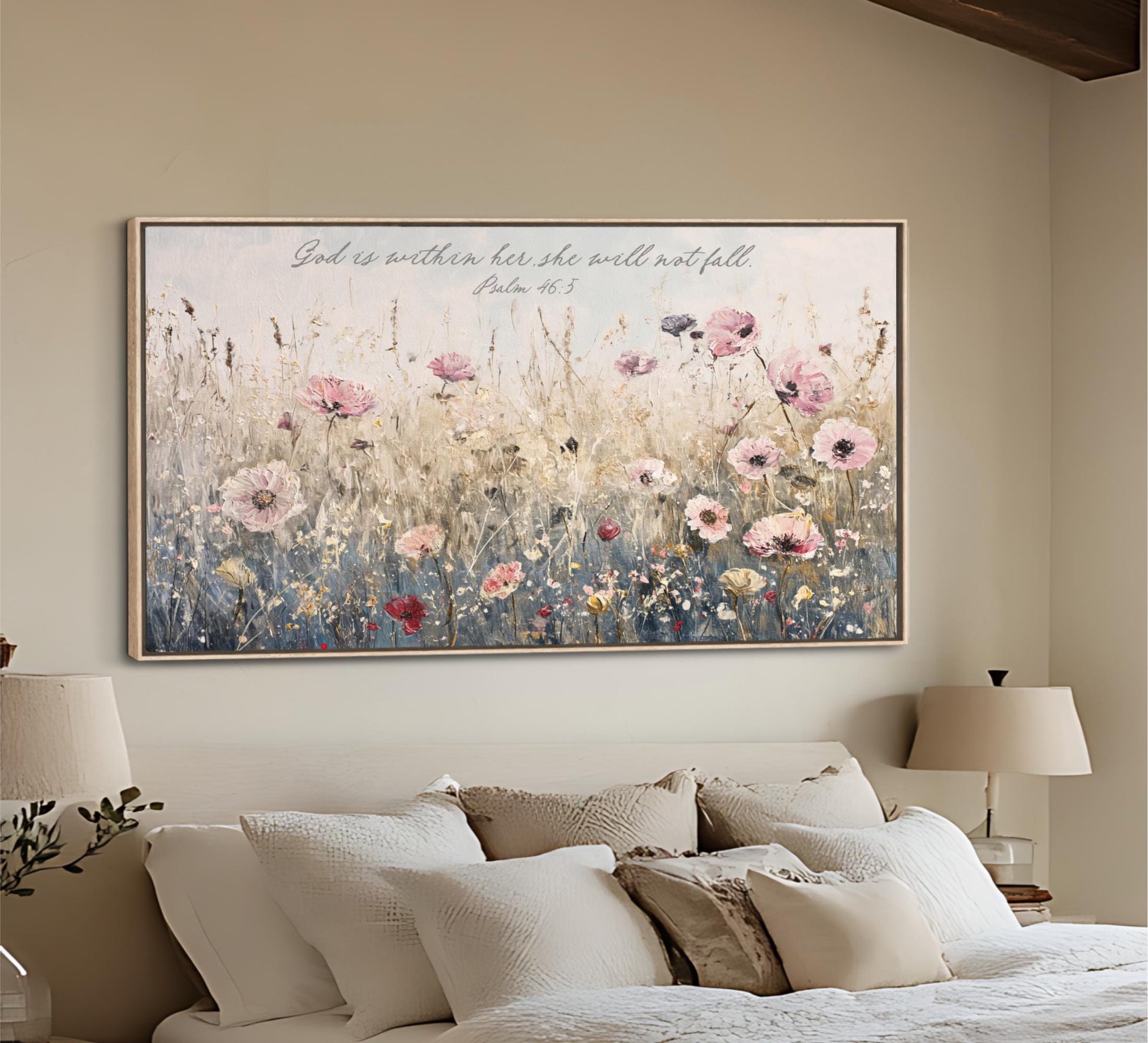 A large framed painting of a field of flowers hangs on the wall above a bed with white pillows and a beige headboard.