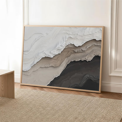 a large abstract painting with a mix of light and dark colors, displayed on a wooden frame and placed on a beige rug on a wooden floor.