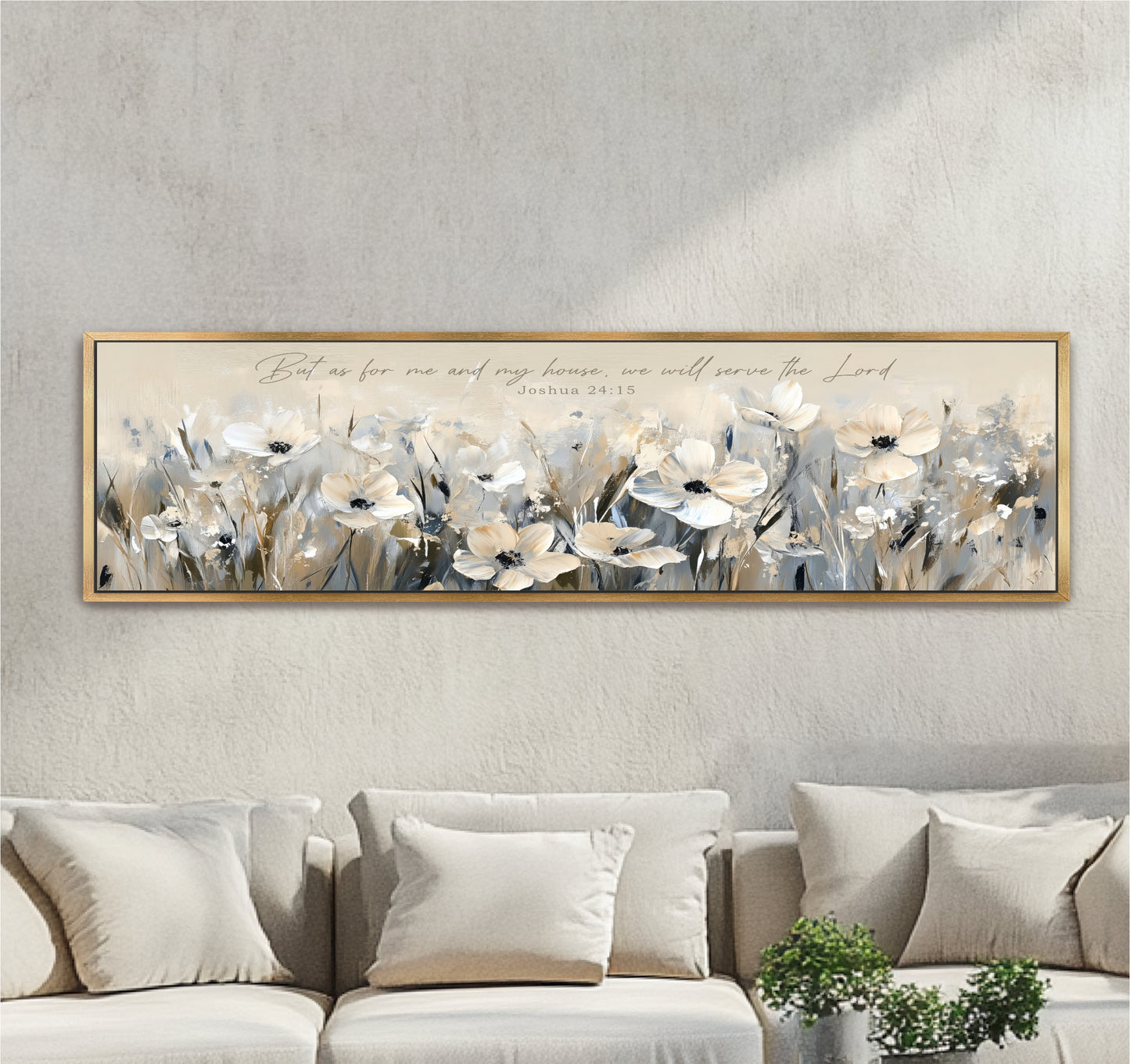 A framed painting of white flowers is hanging on a wall above a beige couch, with a potted plant in the foreground.