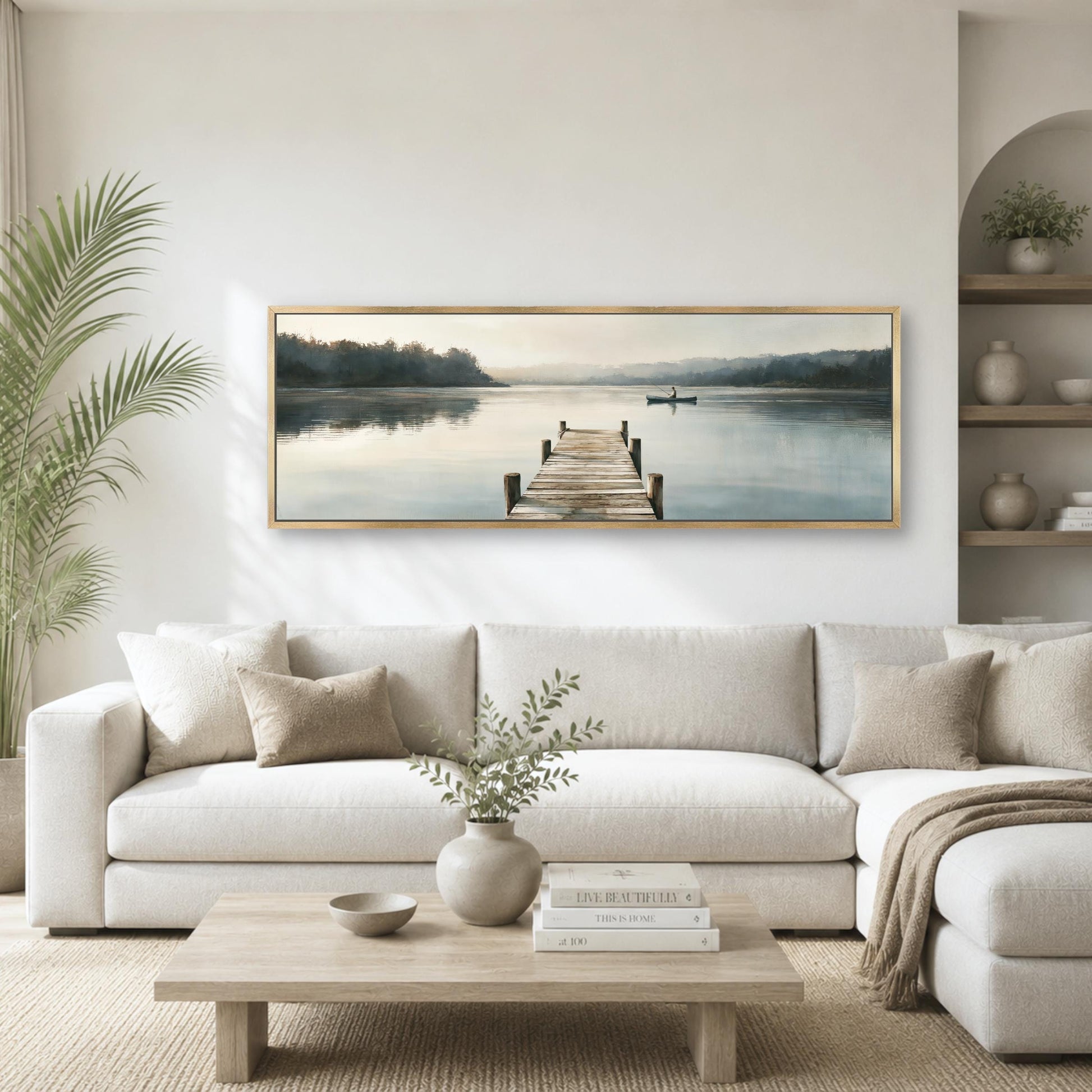 a serene living room with a large painting of a wooden dock leading to a calm lake, surrounded by lush greenery.
