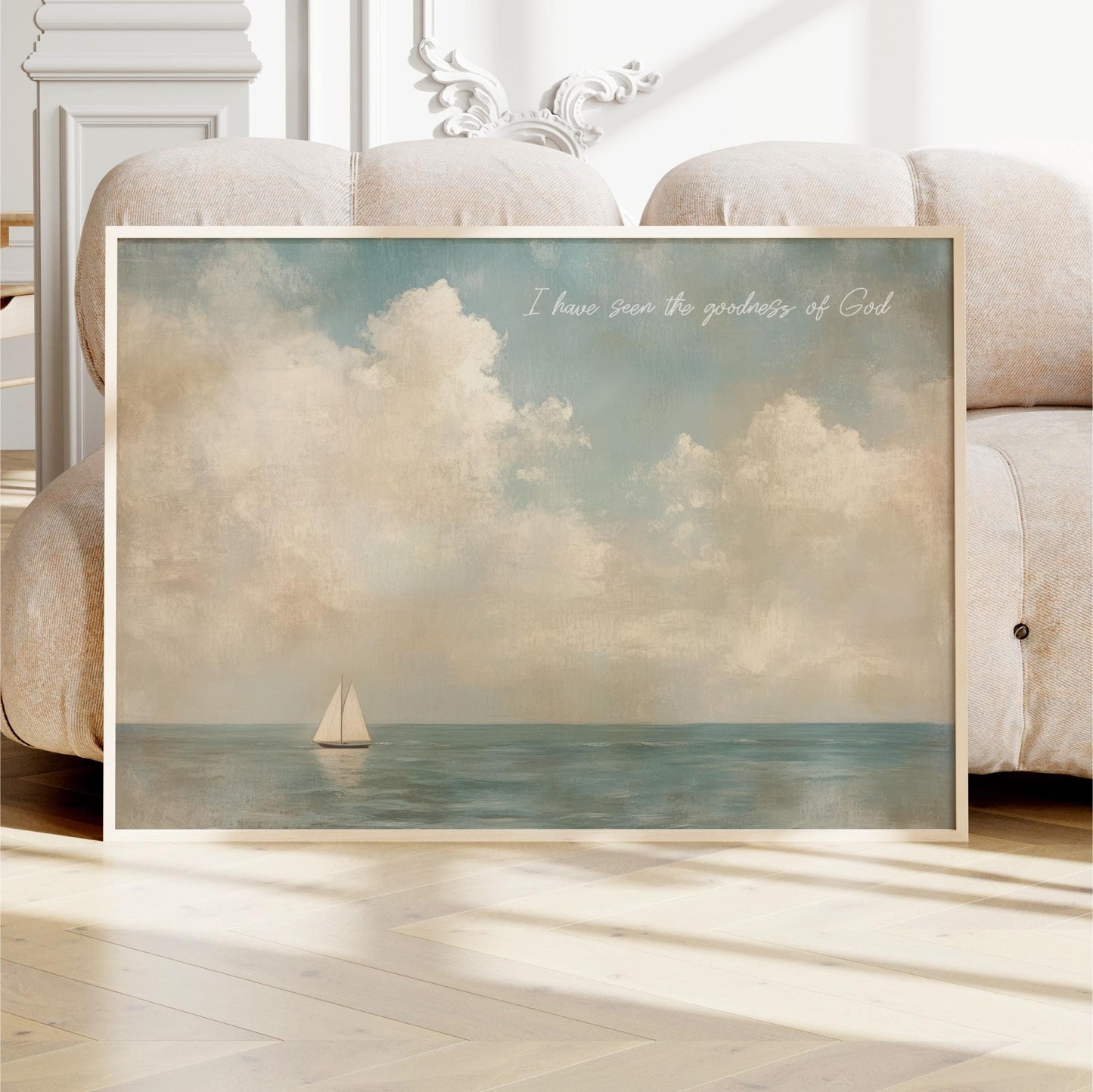 a framed painting of a sailboat on the ocean, with a cloudy sky in the background.
