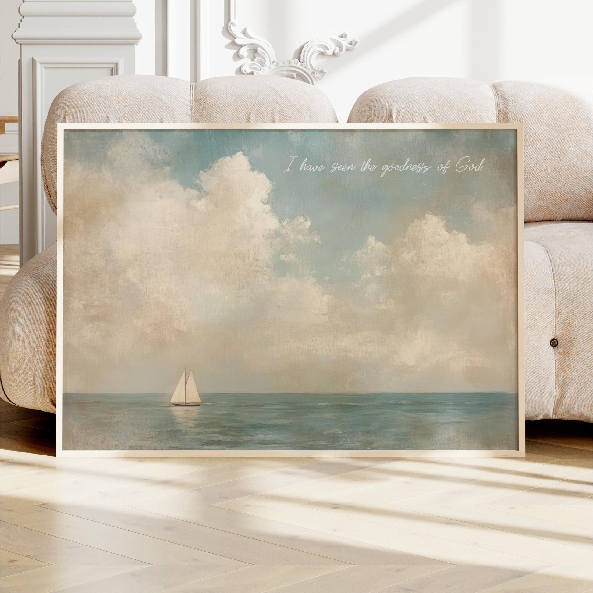 a framed painting of a sailboat on the ocean, with a cloudy sky in the background.