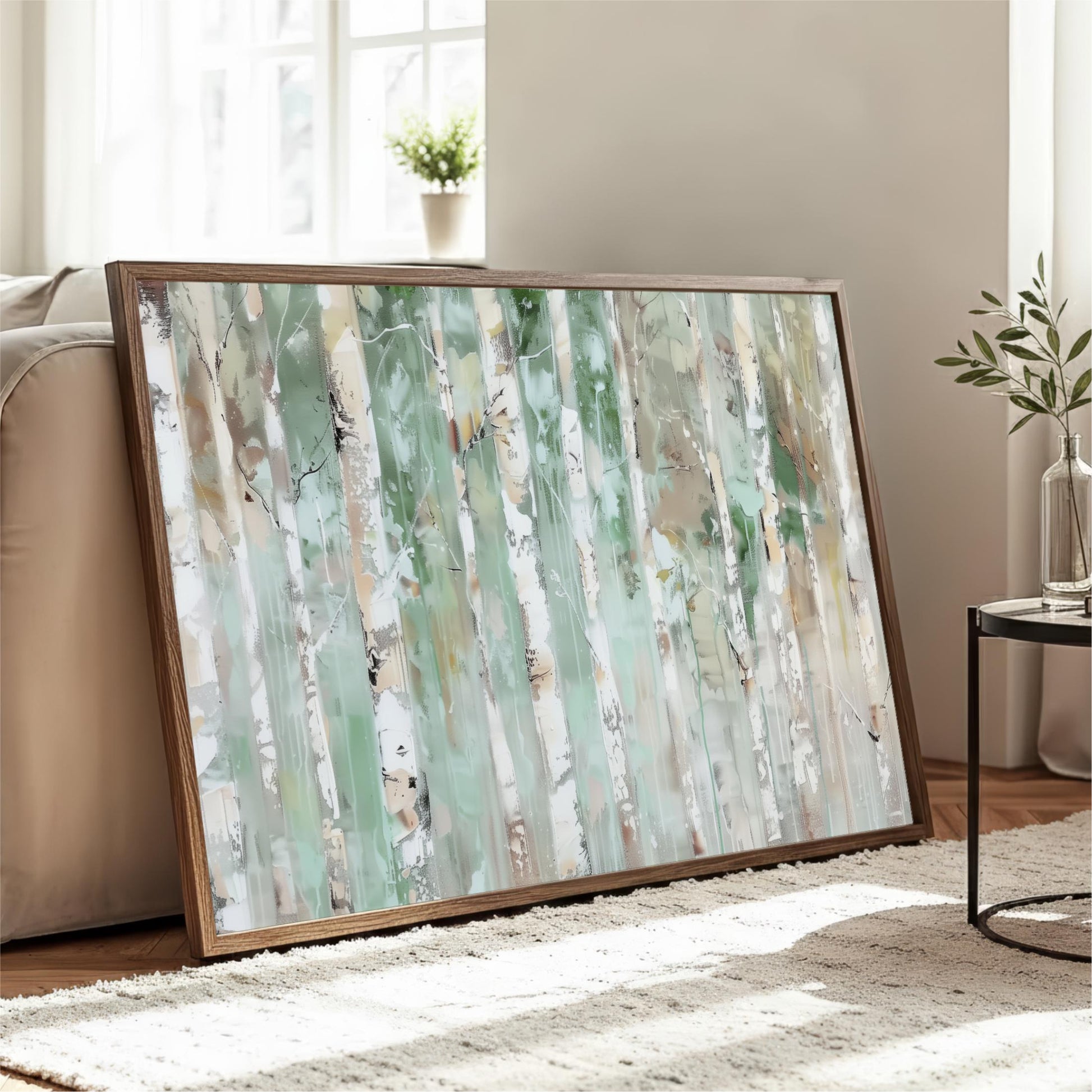 a large, framed painting of a forest scene with tall trees and a lush, green background. The painting is displayed on a wooden frame and is placed on a white rug in a living room setting.