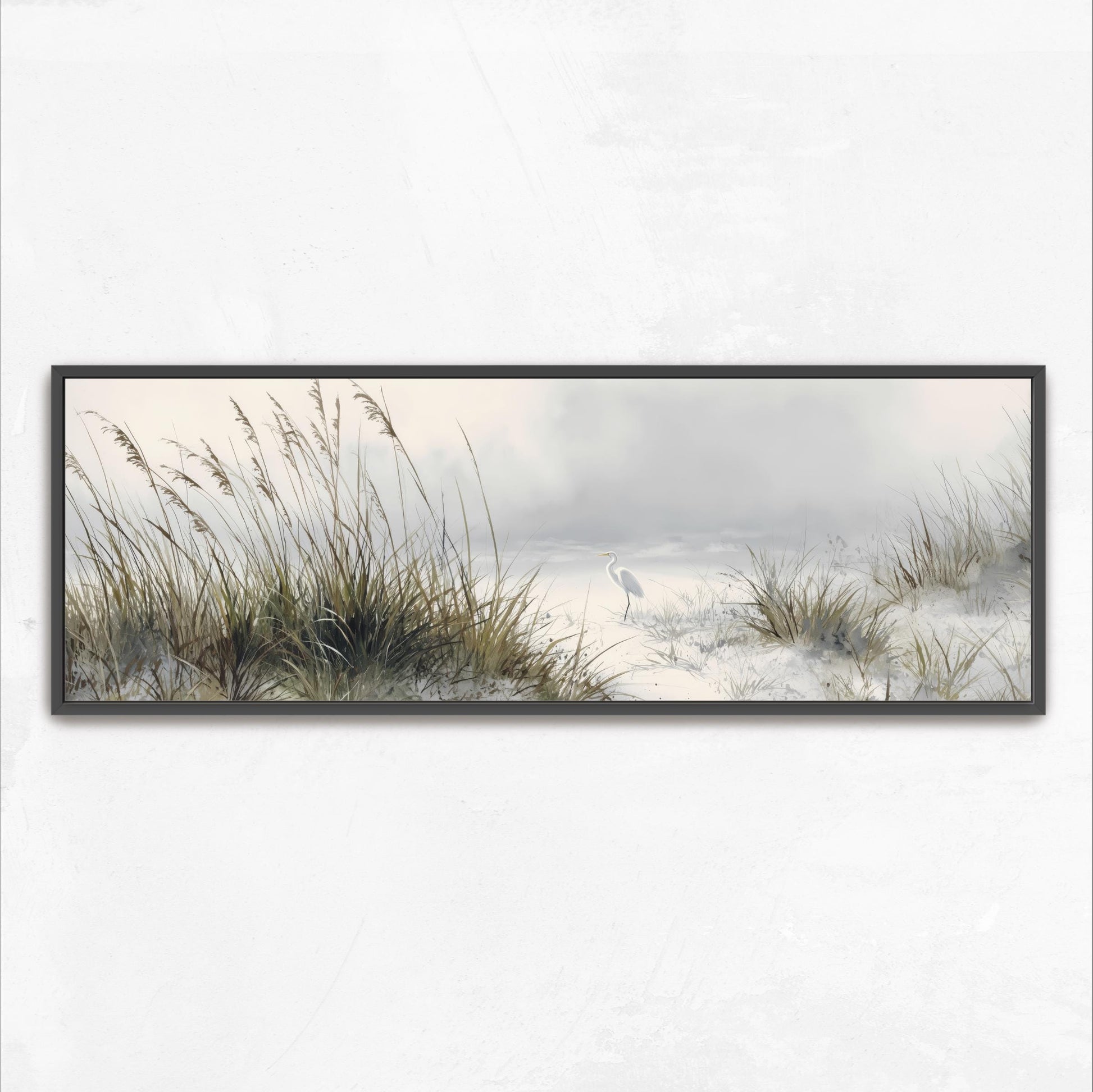A framed painting depicting a serene landscape with tall grasses and a bird standing in the distance.