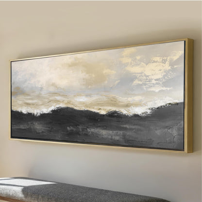 a large, framed painting of a landscape with a cloudy sky and mountains in the background.