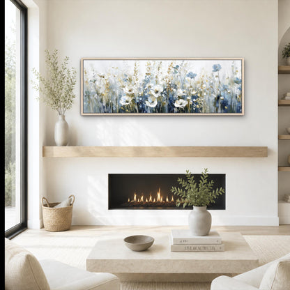 a cozy living room with a fireplace, a coffee table, and a painting of flowers hanging above it. The room has a minimalist and modern design, with a large window providing natural light and a view of the outdoors.