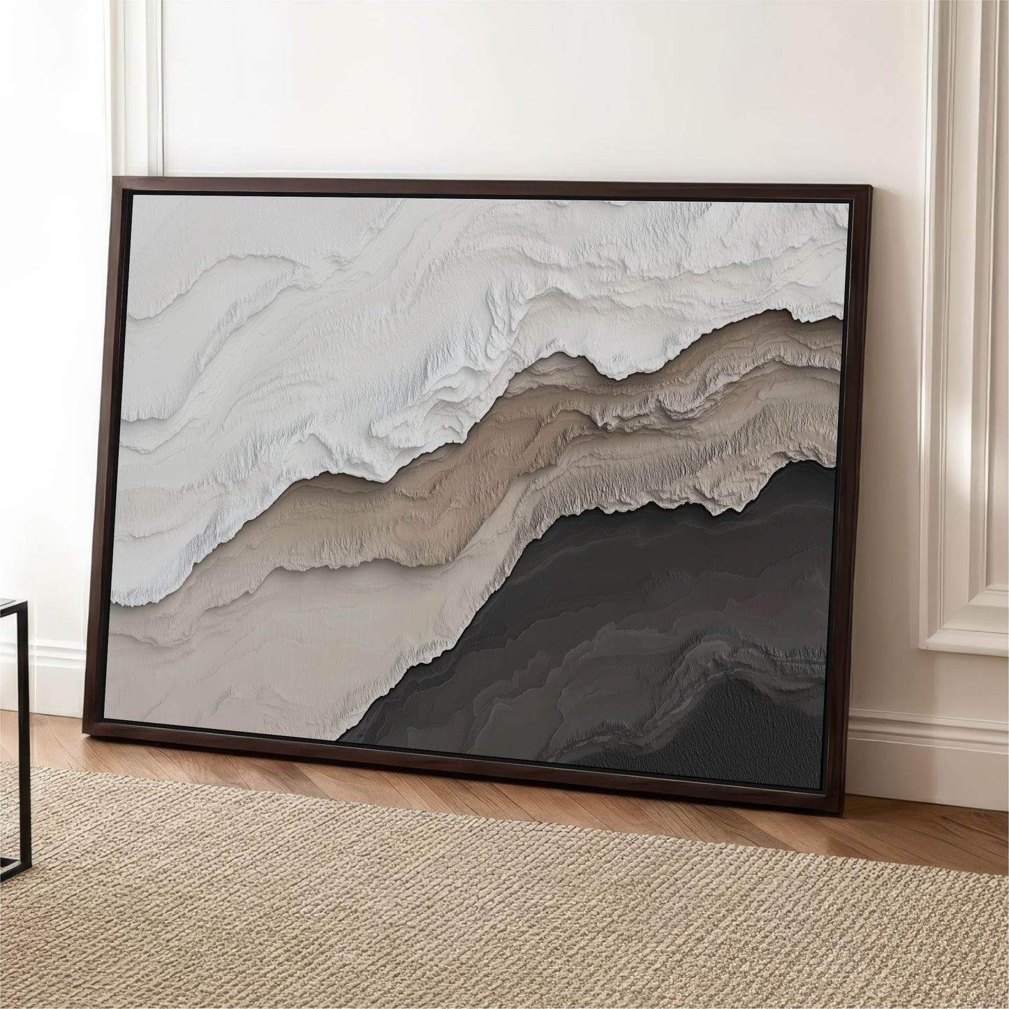 a large abstract painting with a mix of light and dark colors, displayed on a wooden floor against a white wall.