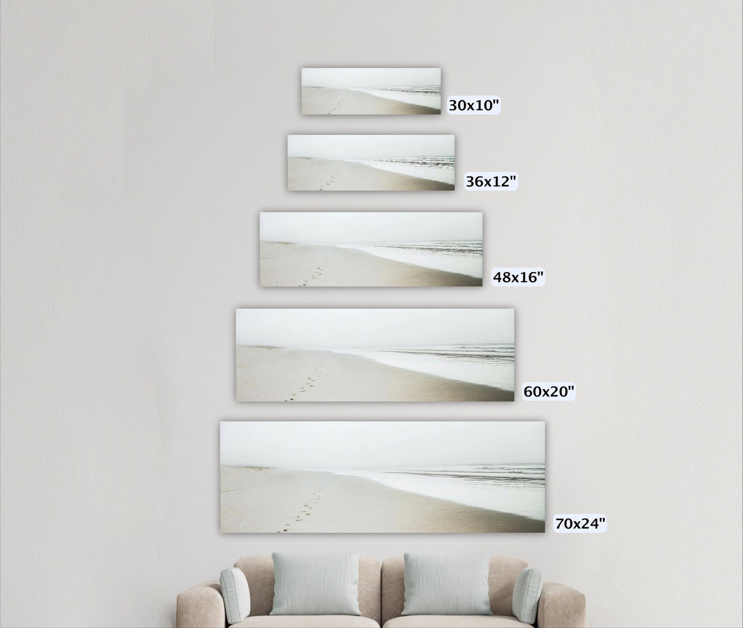 a living room with a couch and three pictures on the wall