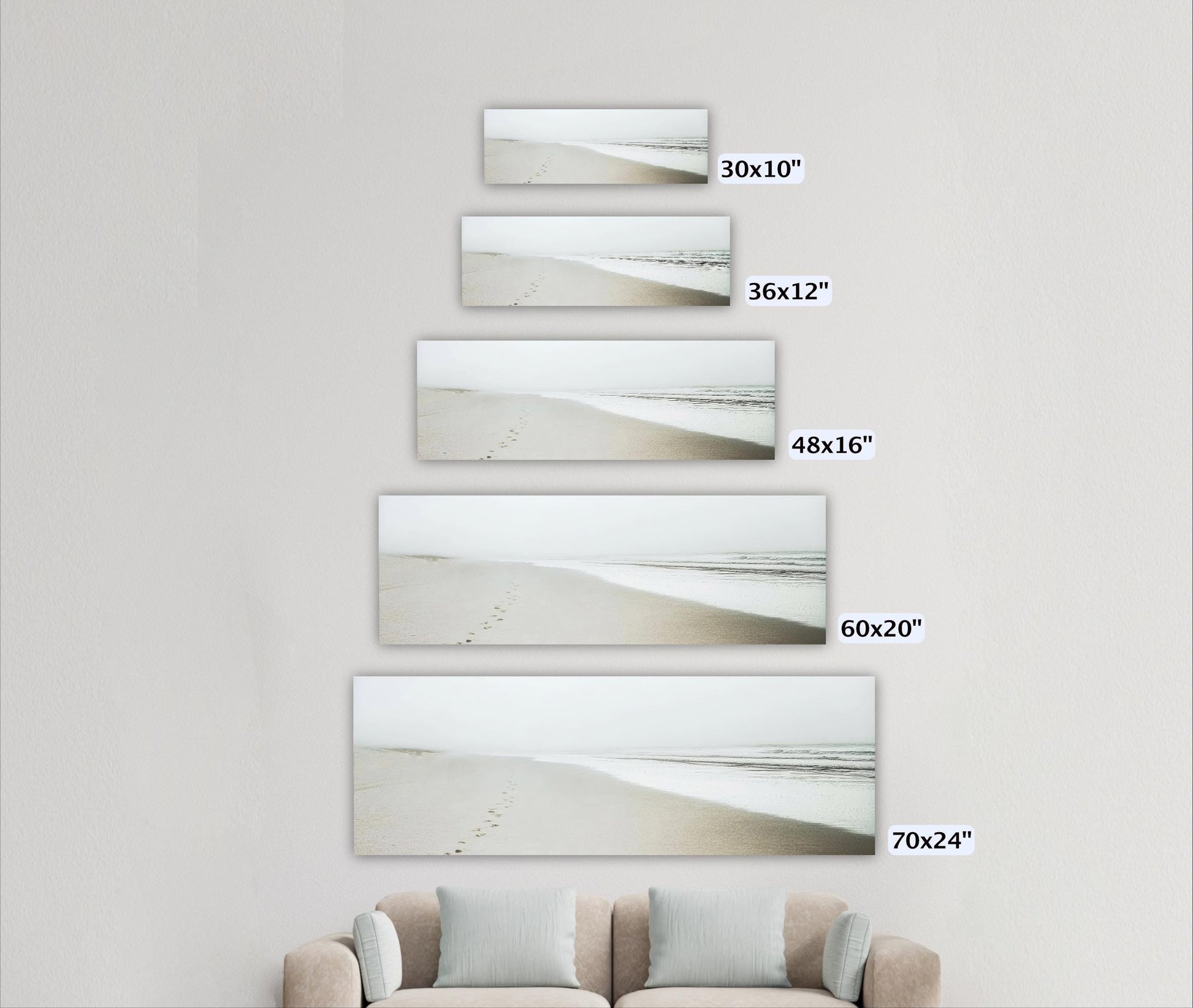 a living room with a couch and three pictures on the wall