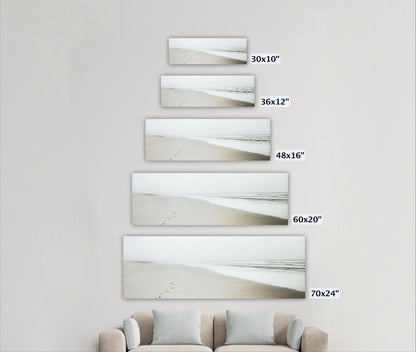 a living room with a couch and three pictures on the wall