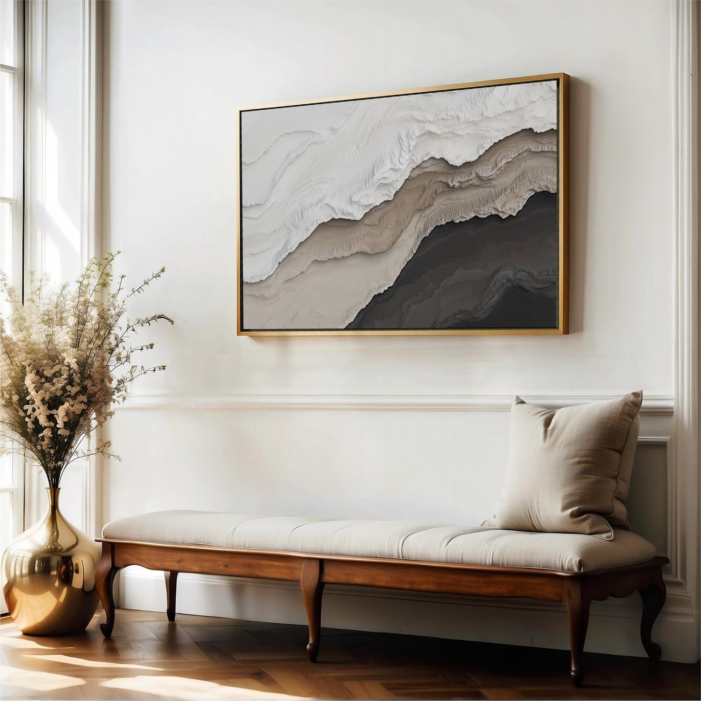 a large abstract painting hanging on a white wall above a wooden bench with a beige cushion. The painting has a mix of light and dark colors, creating a sense of depth and texture. The wooden bench has a classic design with a curved backrest and armrests, providing a comfortable seating area. The arrangement of the bench and the painting creates a visually appealing and inviting atmosphere in the room.