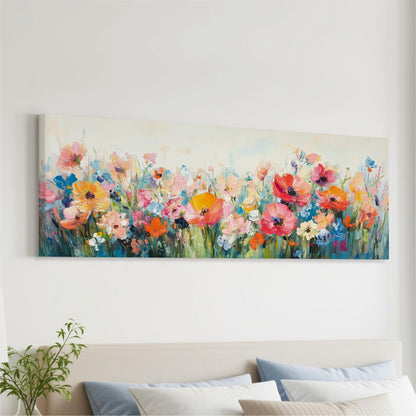 a large, colorful painting of a field of flowers hanging on a wall above a bed with pillows.