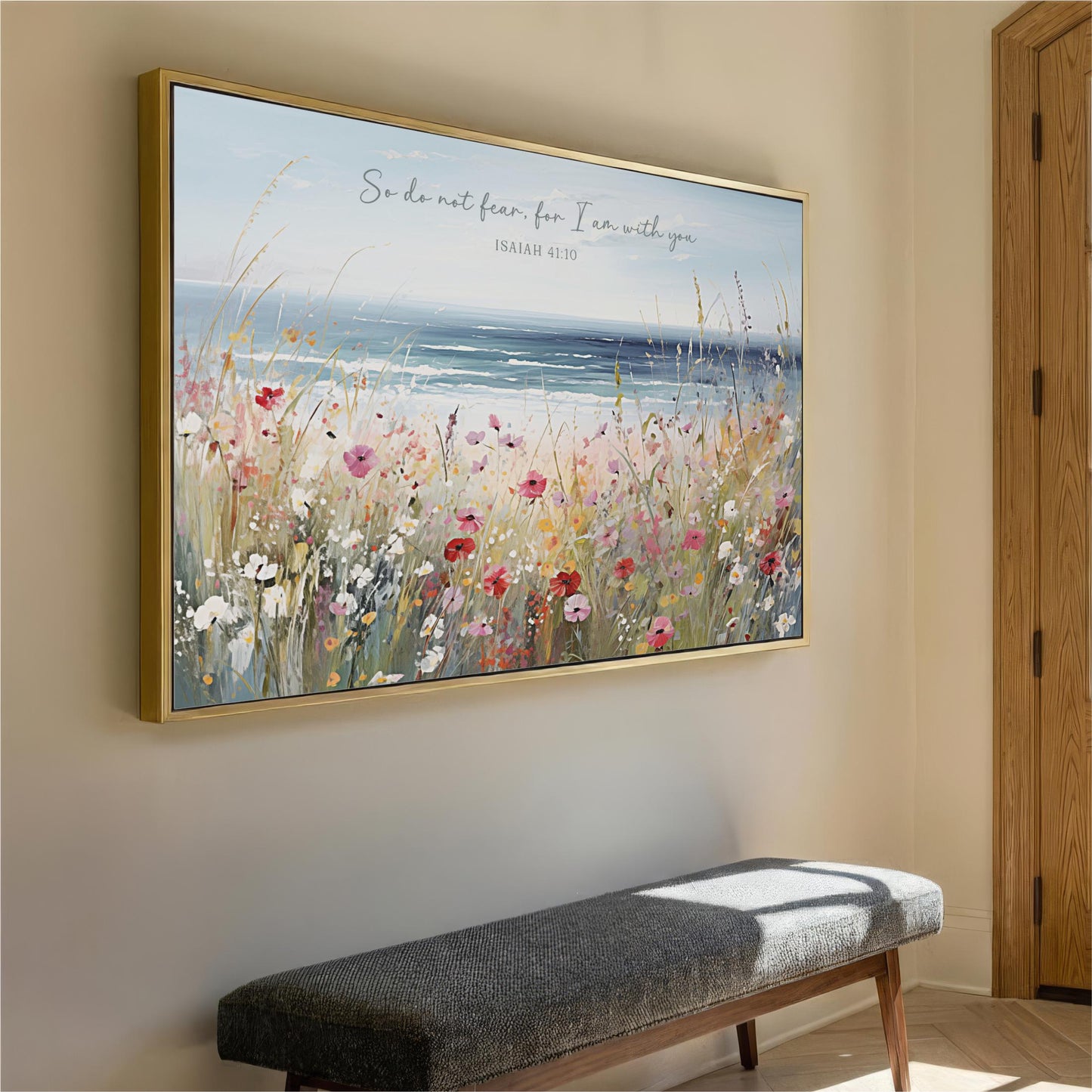 a large framed painting of a field of flowers hanging on a wall, with a bench below it.
