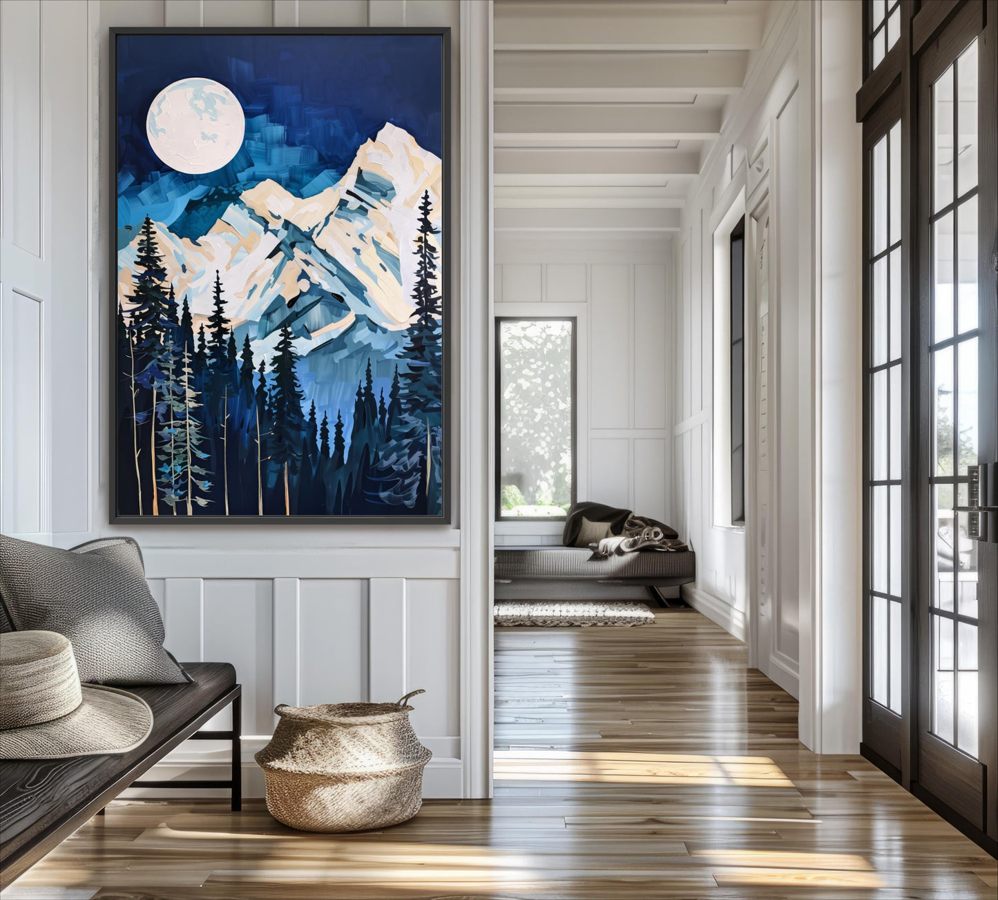 a large painting of a mountain landscape with a full moon, hanging on a wall in a room with a wooden floor and a window.
