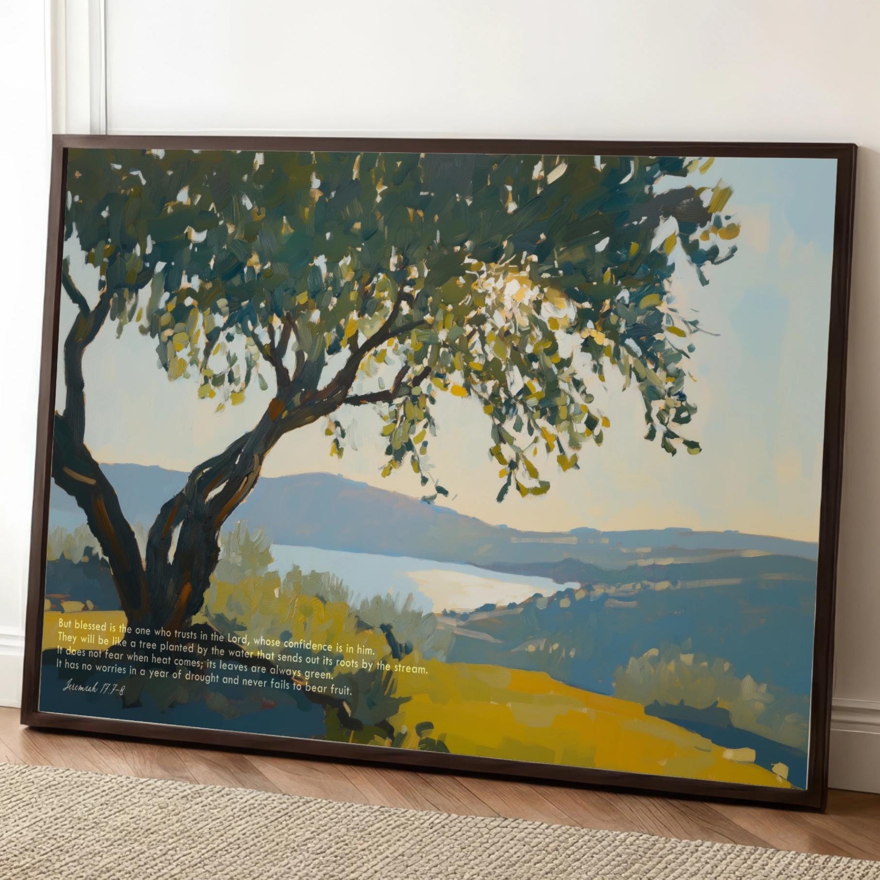 A framed painting depicting a serene landscape with a large tree in the foreground and a body of water in the background.