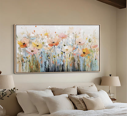 a large, colorful painting of flowers hanging on the wall above a bed with white bedding.